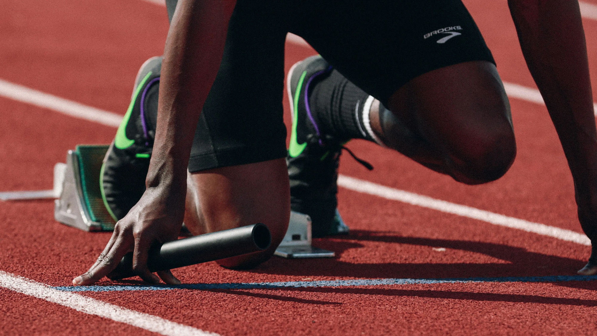 Sprinter set in the starting blocks on a track