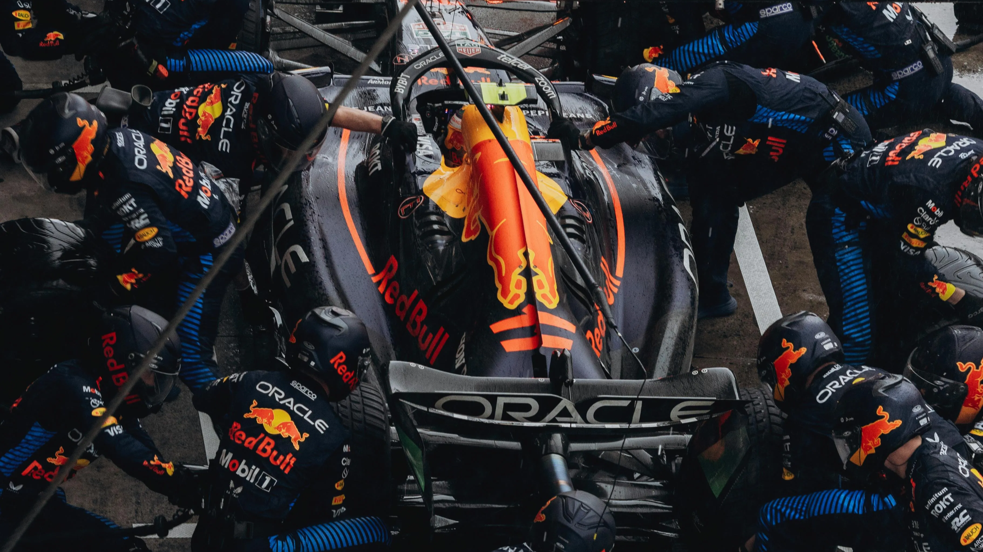 Formula 1 pit stop crew servicing a car